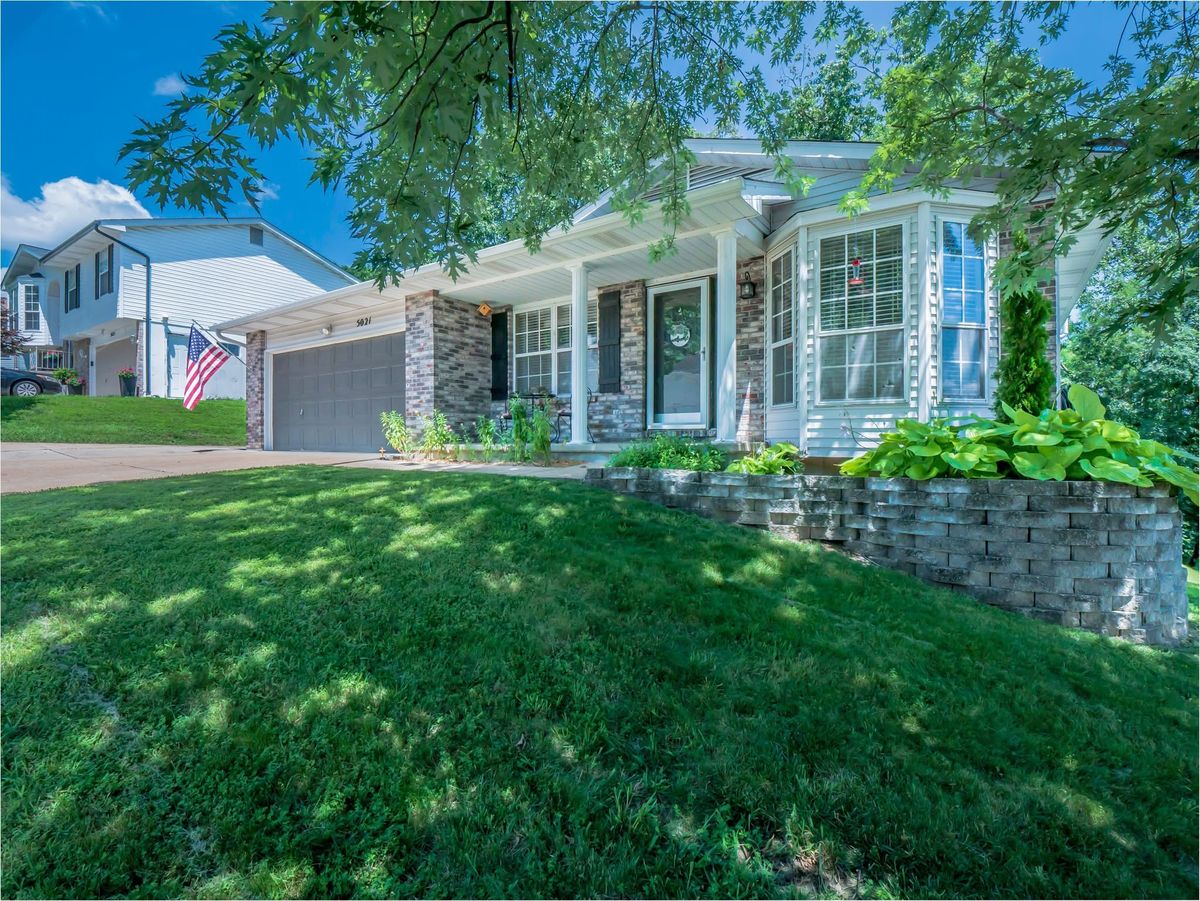 5021 Galena Court, a ranch with a brick front, covered porch, bay window and two-car garage behind a sloped front lawn