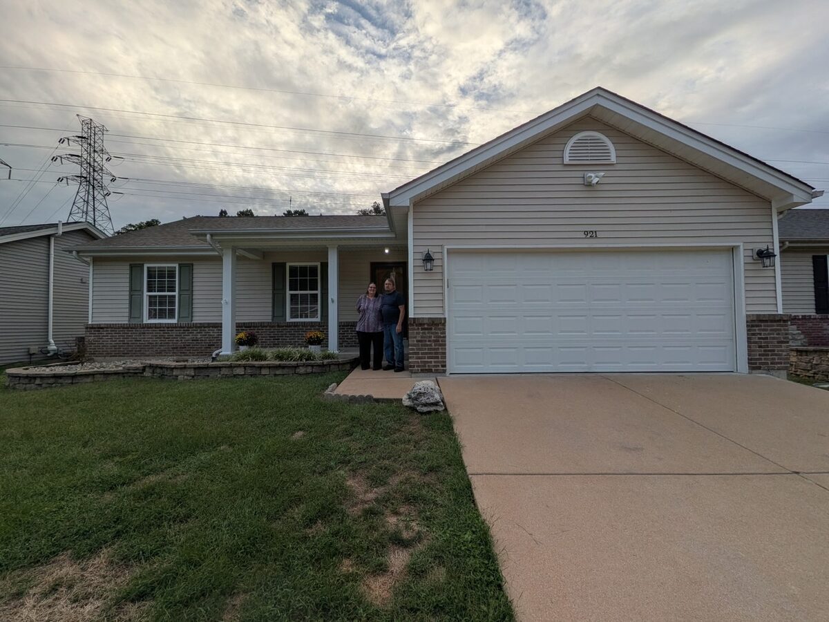 Roy and Karen on the front porch of their ranch at 921 San Luis Drive in Fenton