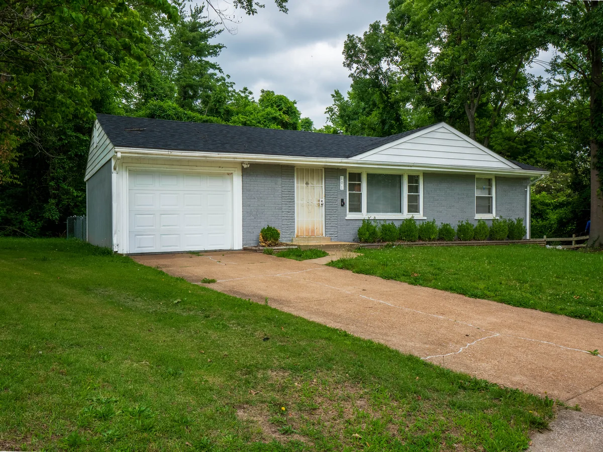 Ranch with an attached garage on a wooded lot in the St. Louis area